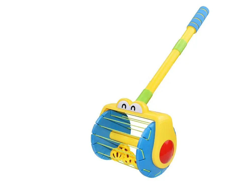 Colorful toy rake with a cartoon face on a white background